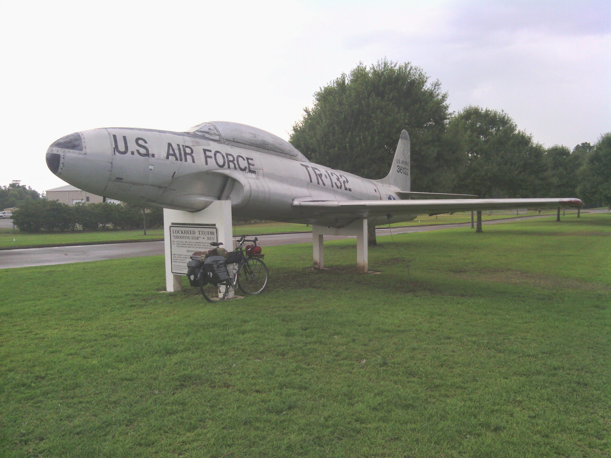 bike propped up against replica fighter pilot